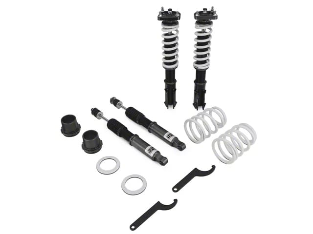 Adjustable coilover suspension kit with springs, shocks, and spanner wrenches for a Ford Mustang.