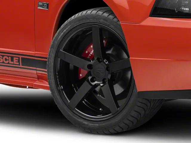 Black five-spoke aftermarket wheel and performance tire installed on a 1999&ndash;2004 Ford Mustang GT.
