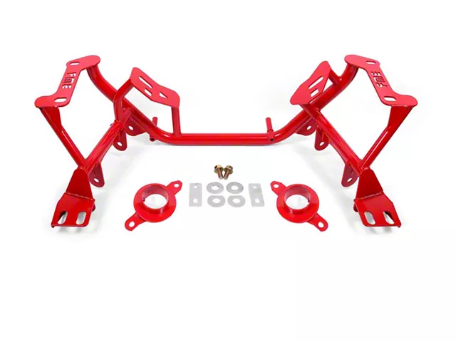 Red tubular subframe connector kit for an SN95 Mustang, featuring chassis reinforcement braces, mounting brackets, and hardware designed to reduce chassis flex and improve handling performance.